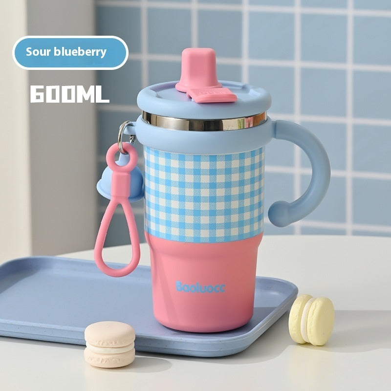 Pink and blue tumbler with checkered pattern on a tray with cookies against a tiled wall background