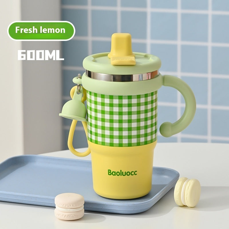 Yellow and green cup with checkered pattern on a tray against a tiled wall background